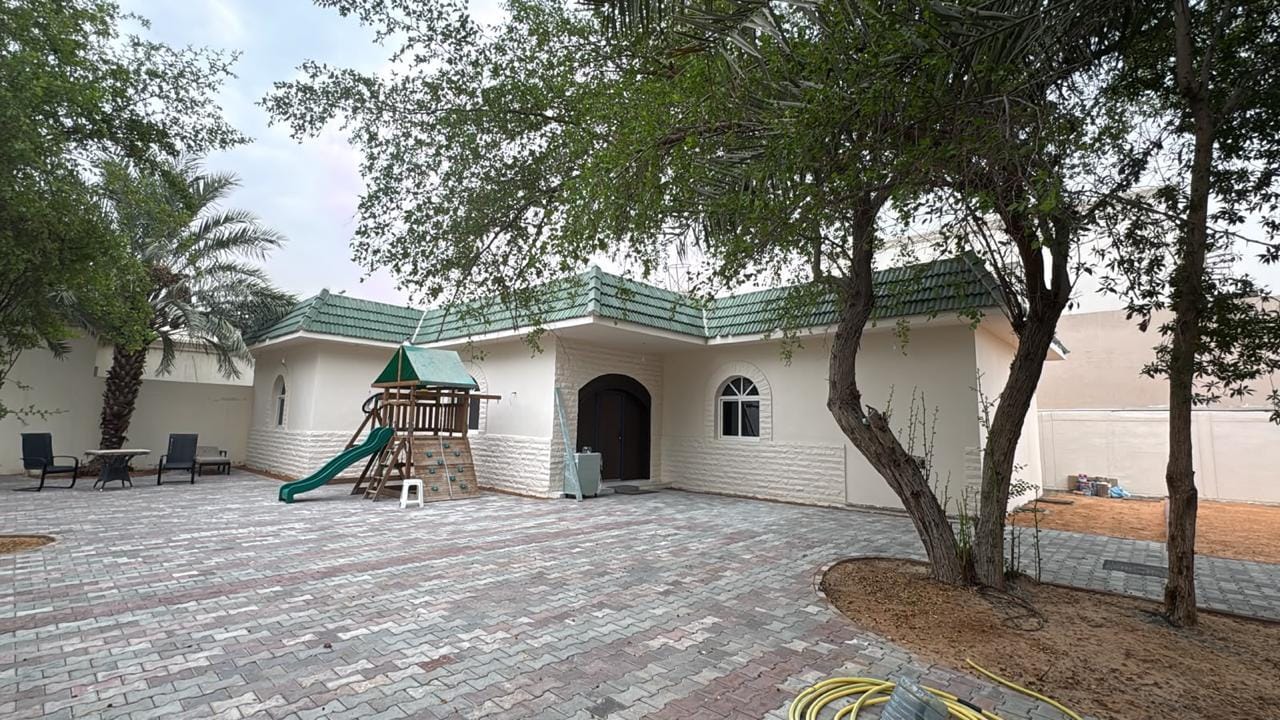 Renovated villa courtyard with new brick paving and repainted boundary walls in Al Quoz, Dubai