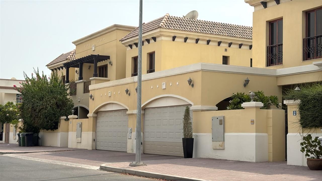 Twin arched garage bays and pergola balcony on a Mediterranean-style villa in Jumeirah, Dubai