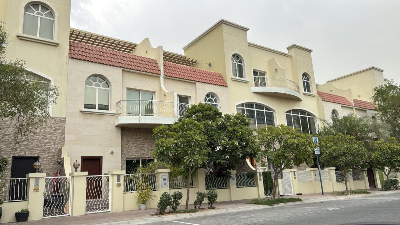 Stone-clad townhouse entrances with wrought-iron gates in JVC, Dubai